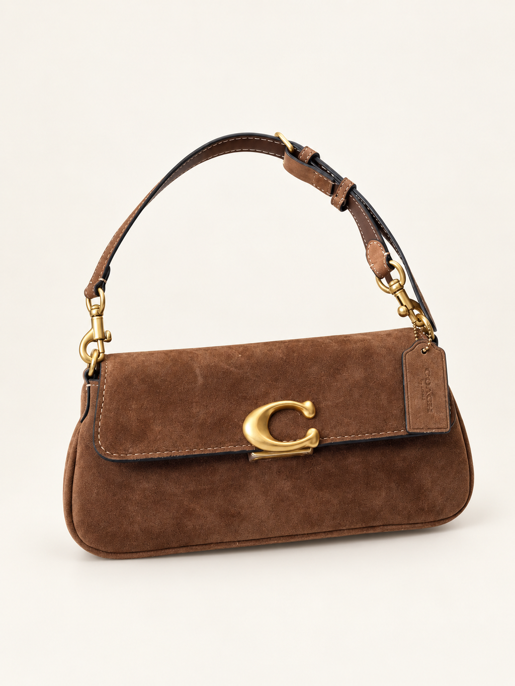 Coach Suede Jet חום – חזית בזווית על רקע שנהב