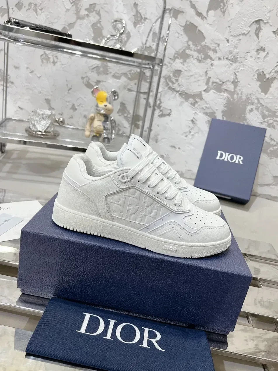 GALLERY X white leather low-top sneakers with embossed Dior branding and perforated toe box.